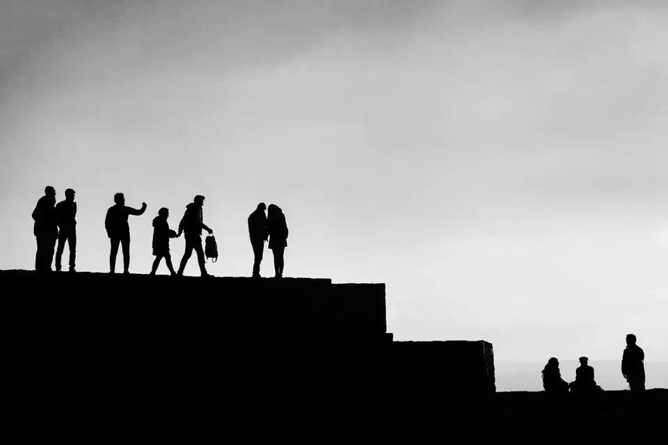 People moving through an open landscape, representing a financial transition after job loss